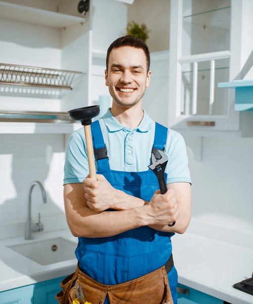 cheerful-male-plumber-holds-wrench-and-plunger-resize.jpg